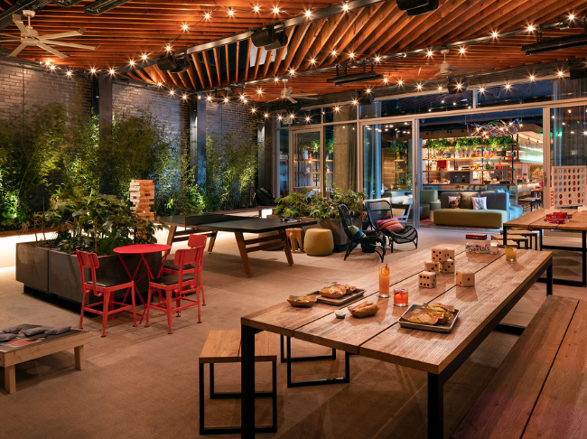 The Backyard with tables, lights, and food